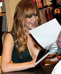 Jennifer_Lawrence_wearing_a_cute_low_cut_green_dress_at_a_book_signing_for_The_Hunger_Games_54.jpg